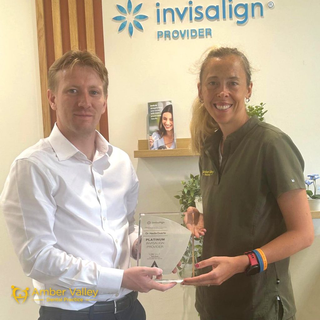 Dr Nadia Duarte receiving the Invisalign Platinum Provider plaque at Amber Valley Dental Practice in Alfreton